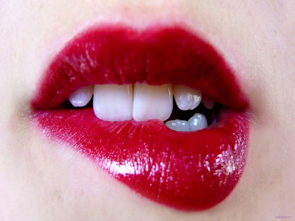 Female lips with red lipstick closeup. 