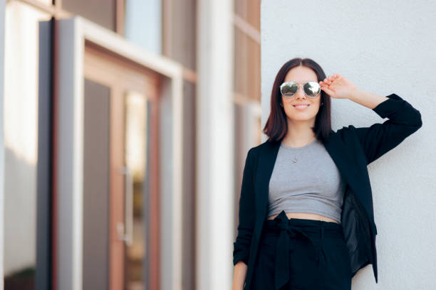 Stylish elegant girl in business casual outfit  wearing trendy shades